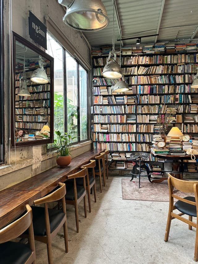 Reading room with old wooden tables and book walls
