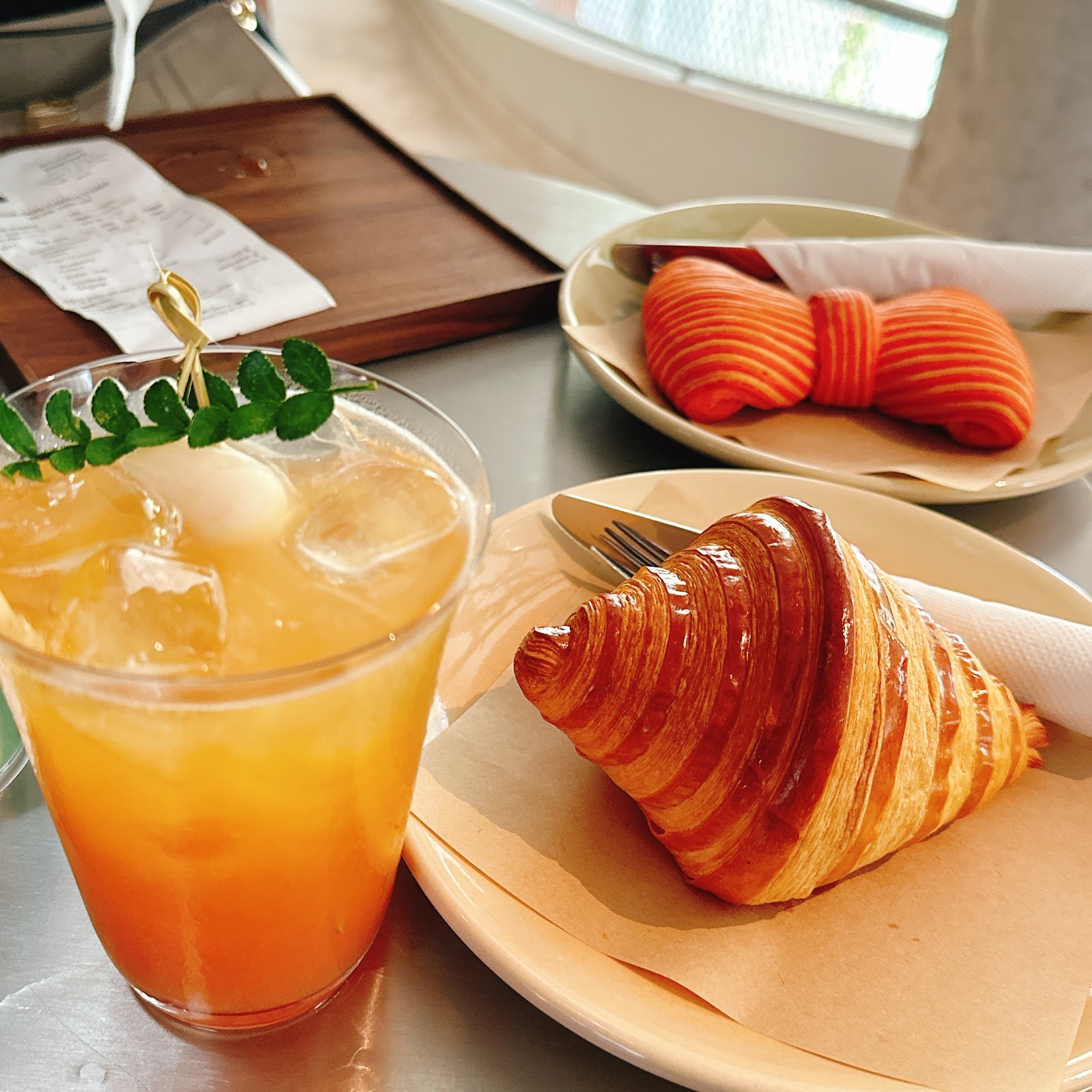 Iced signature drink and the red bow-tie croissant