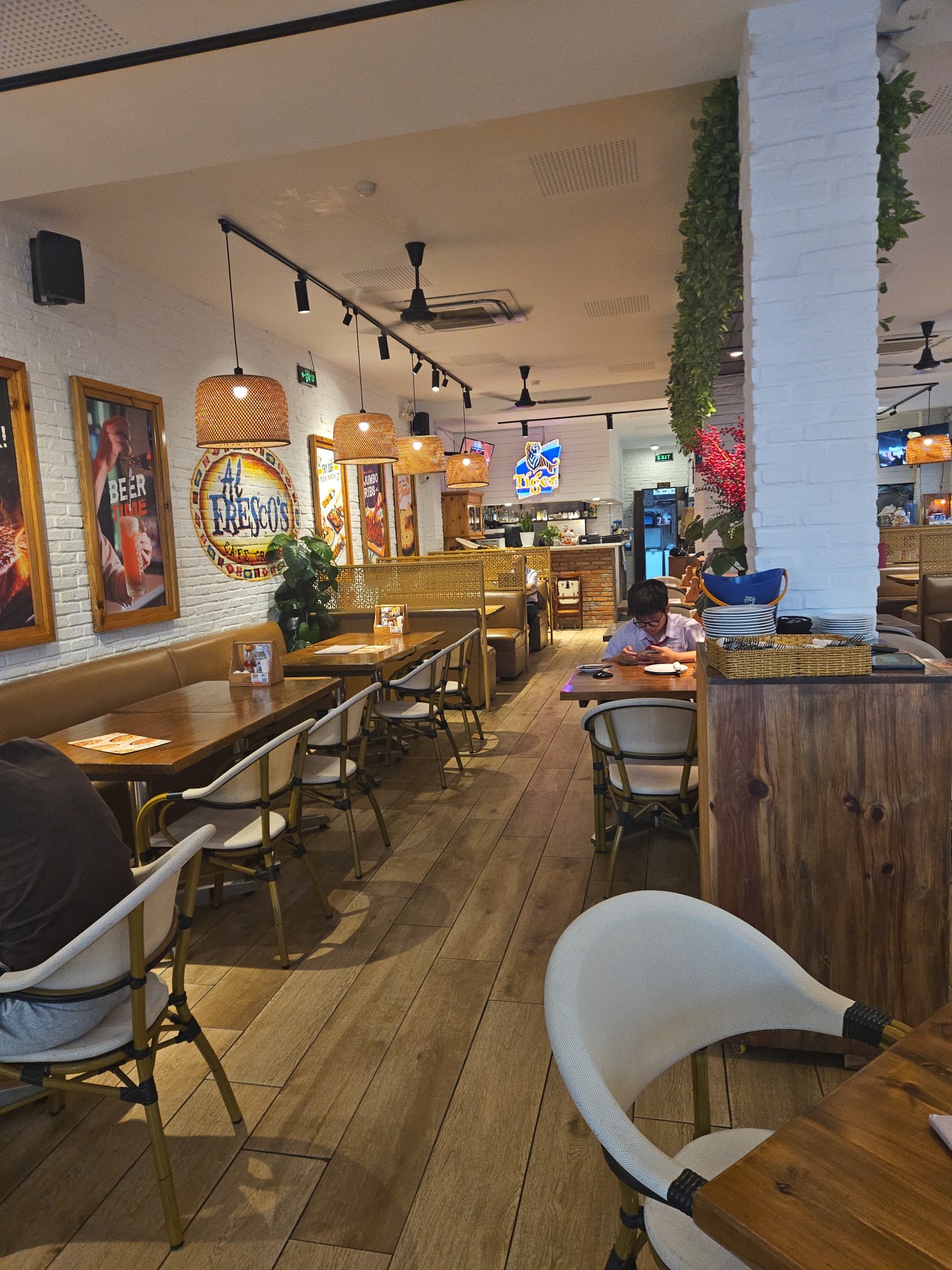 The dining room with rattan lamps and whitewash brick