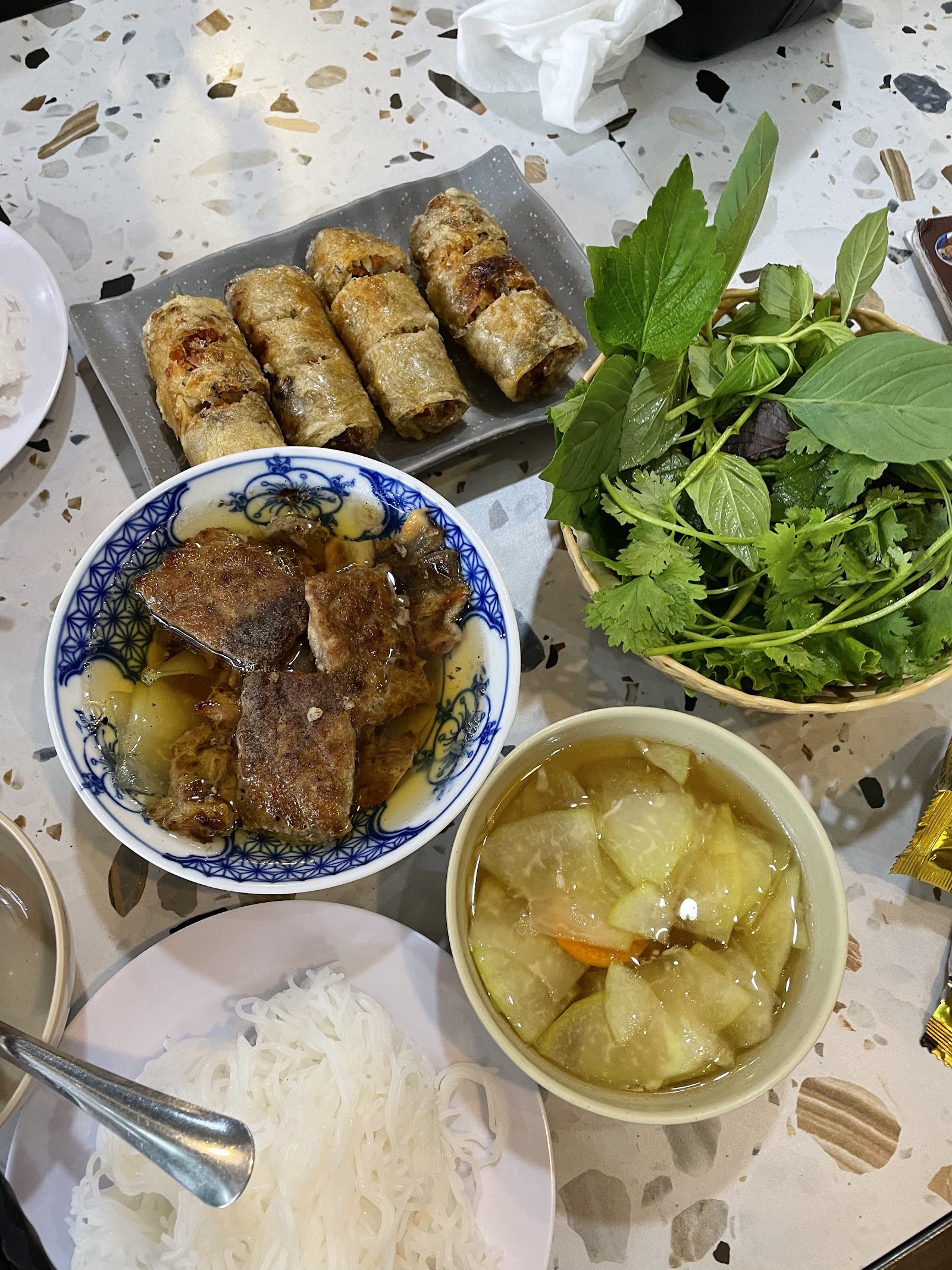 A bún chả spread — vermicelli, charcoal-grilled pork, herbs and sweet-sour dipping sauce