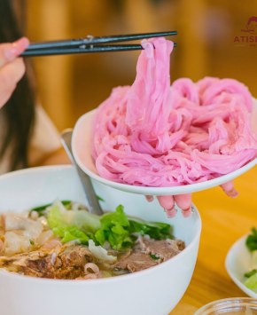 Pink artichoke noodles lifted — the pink comes from Da Lat artichoke