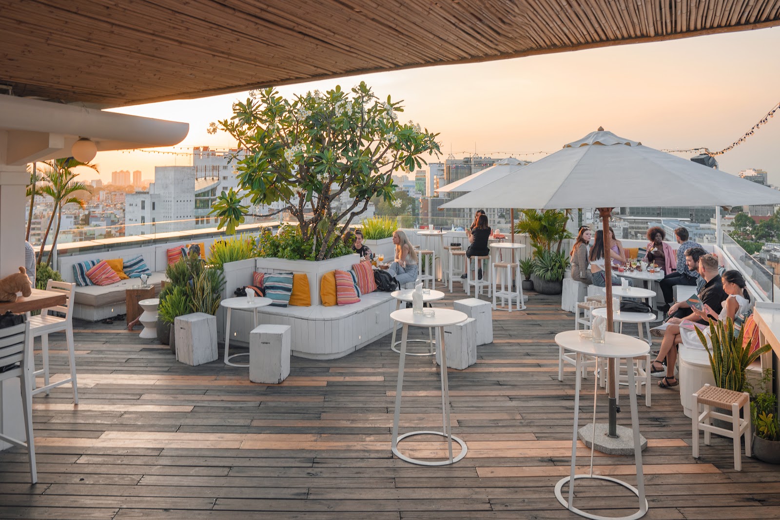 Rooftop terrace at golden hour — amber sky over the Banana Mama terrace