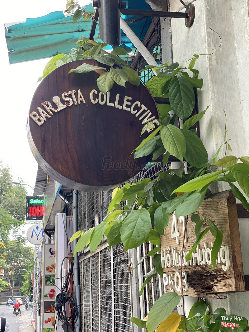 The round wooden Barista Collective sign — 41 Ho Xuan Huong