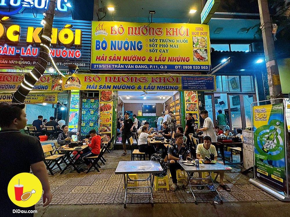 Close on the yellow BÒ NƯỚNG KHÓI sign