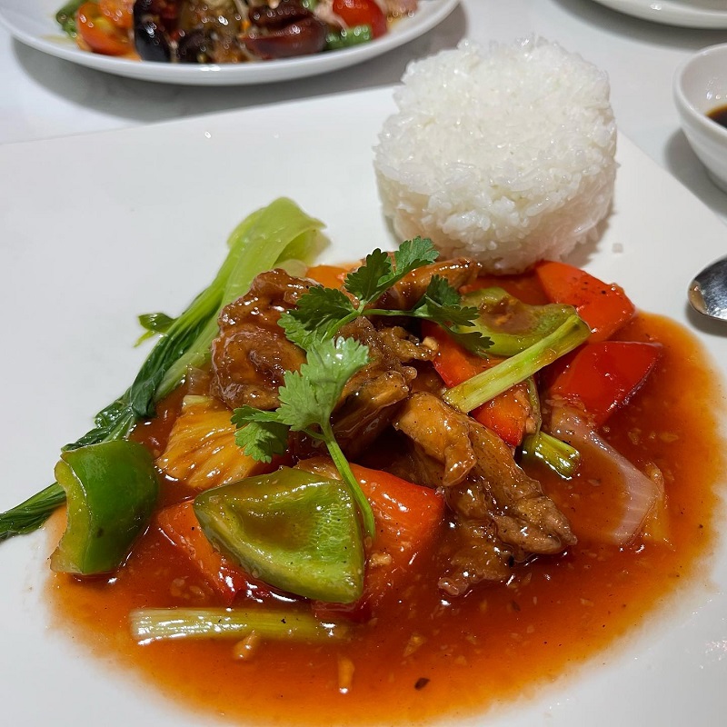 Stir-fried meat with peppers and a mound of steamed rice