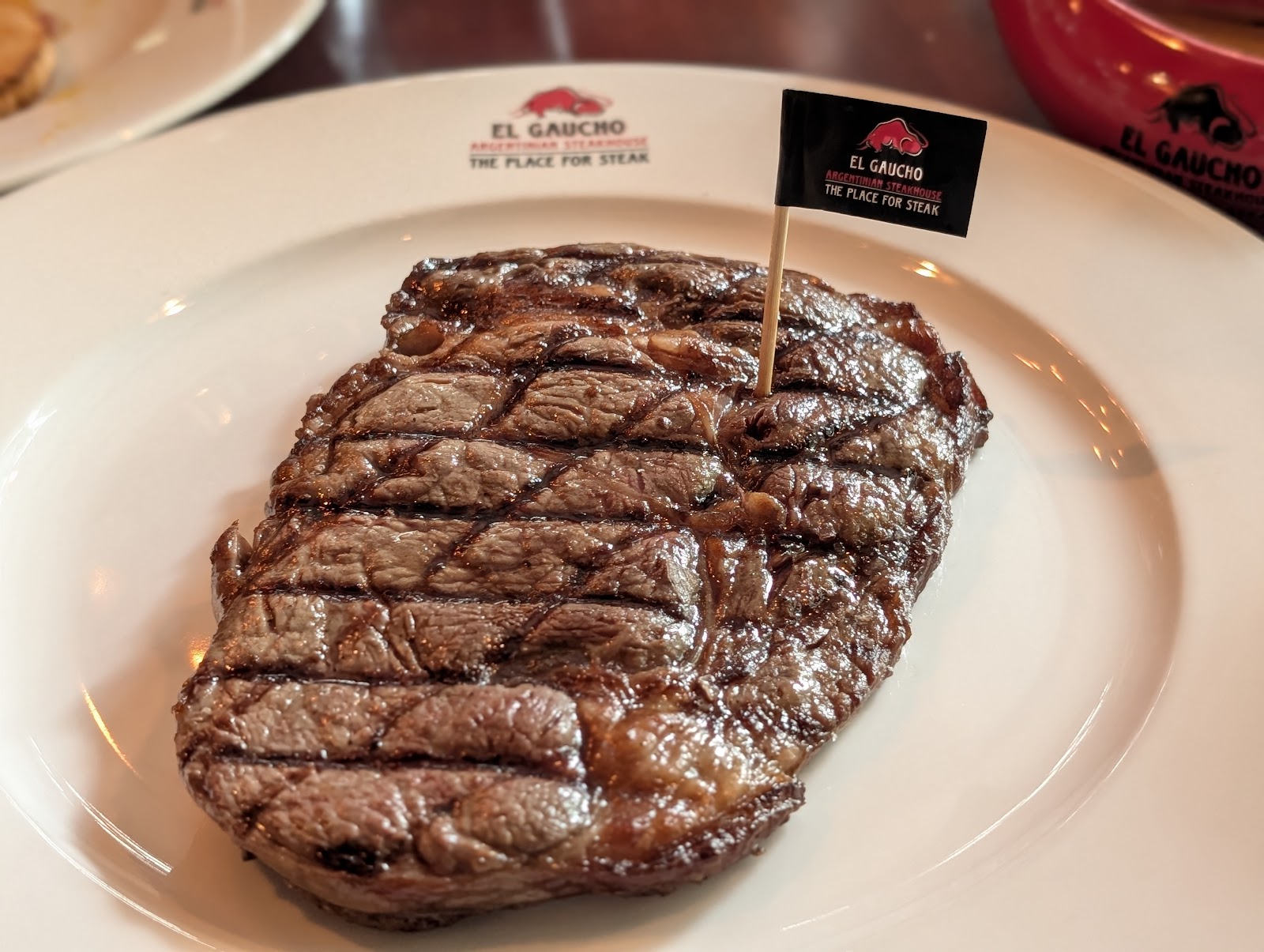 The grilled ribeye with crosshatch marks and the El Gaucho flag pick