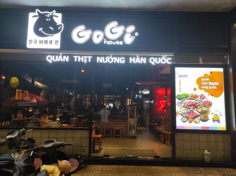 GoGi's glowing smiling-cow sign at night (another branch, danang.style)