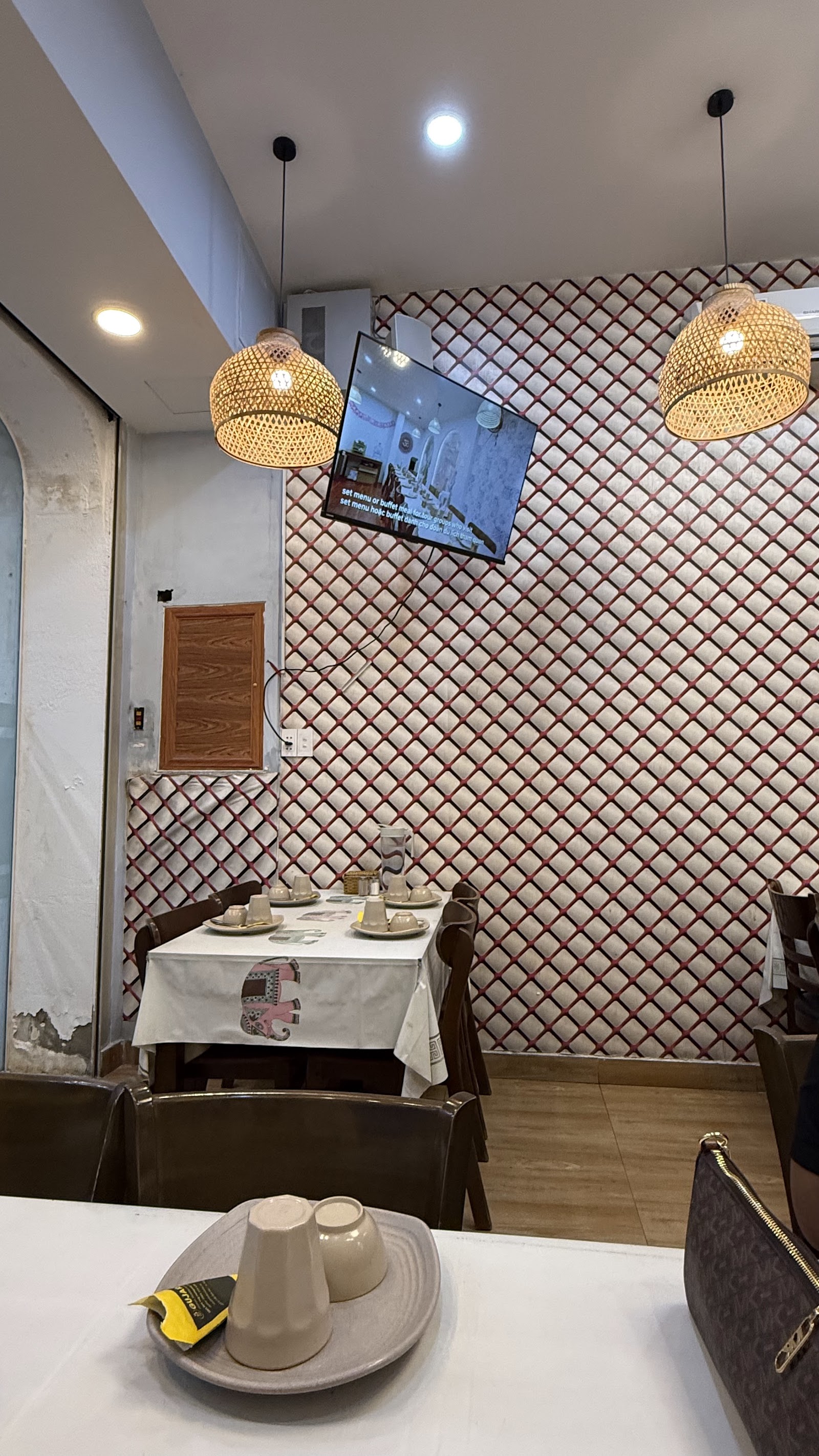 Woven rattan shades and the elephant-print tablecloths