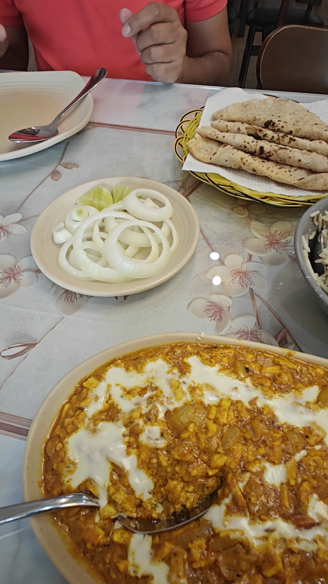 Paneer with a cream swirl, onions and roti