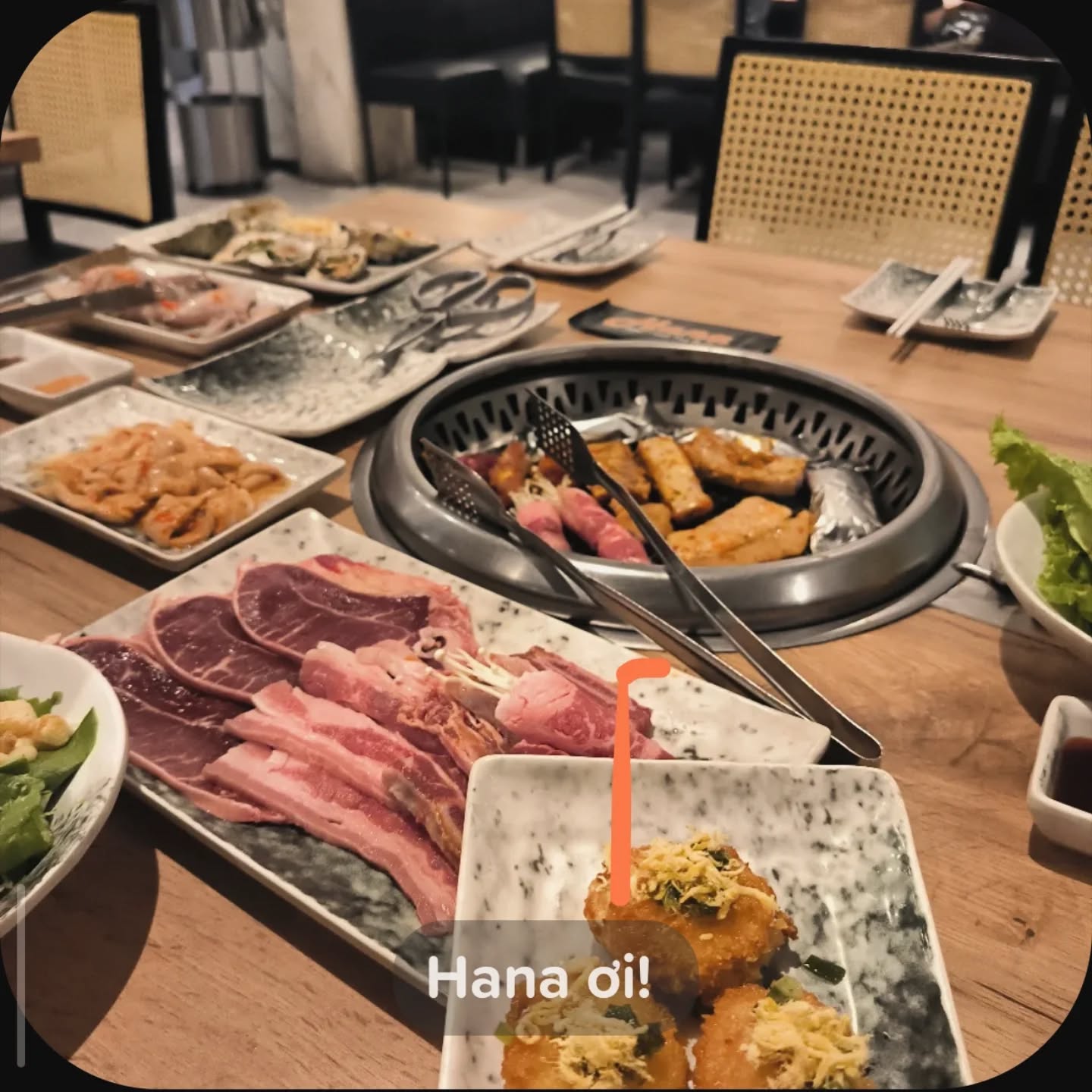 Grill table with raw meats, oysters and a tabletop grill