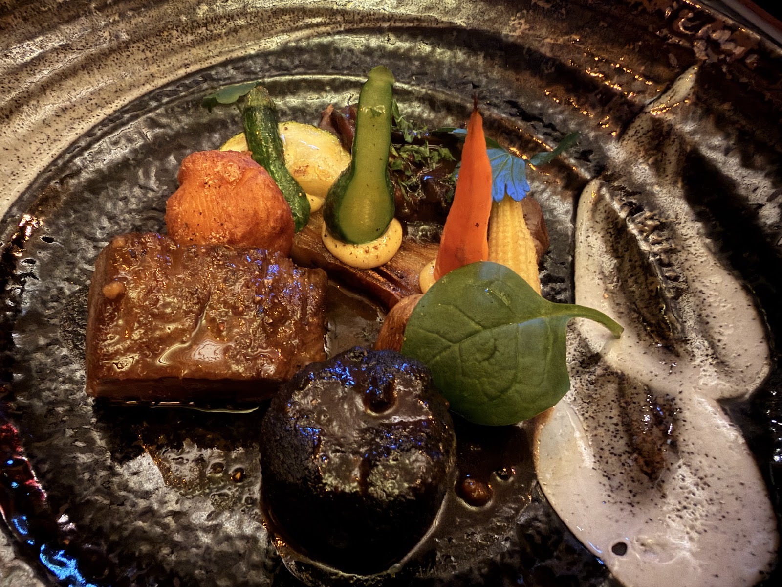 Braised beef with garden vegetables, jus and foam