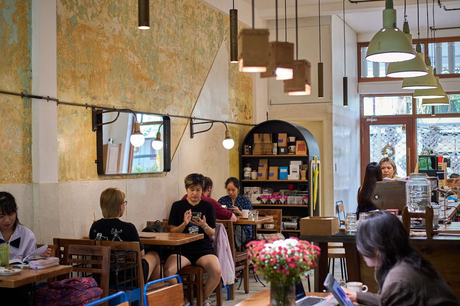 Manki — weathered ochre plaster, wooden counter and pendant light
