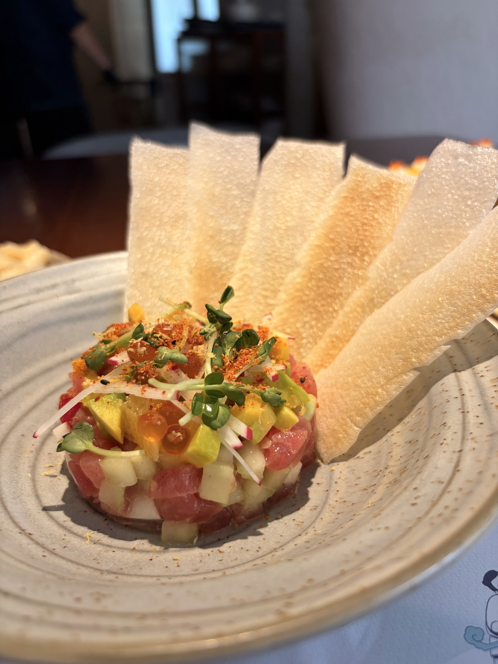 Tuna tartare tower with avocado, ikura and rice crackers