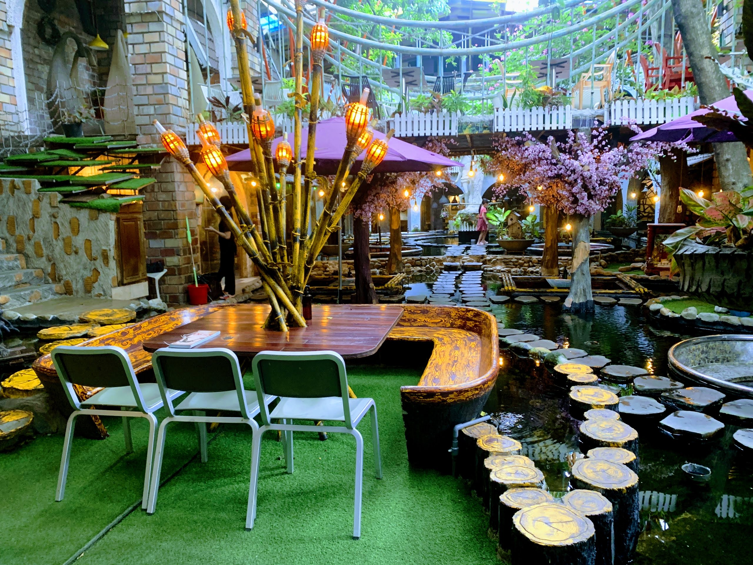 Wooden boat table on the koi pond