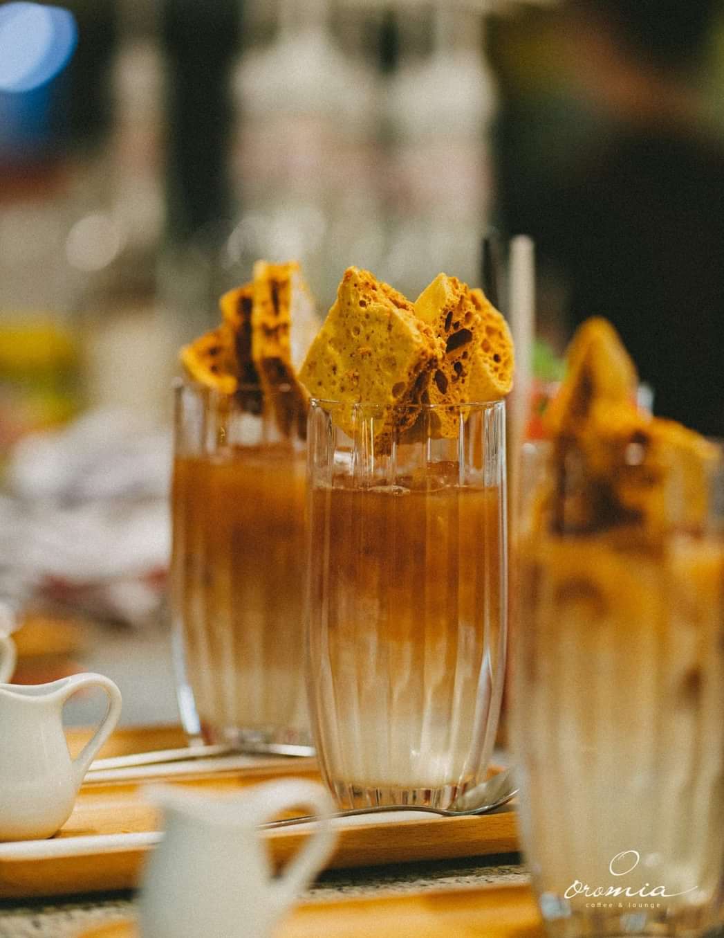 Two iced coffees crowned with dalgona candy