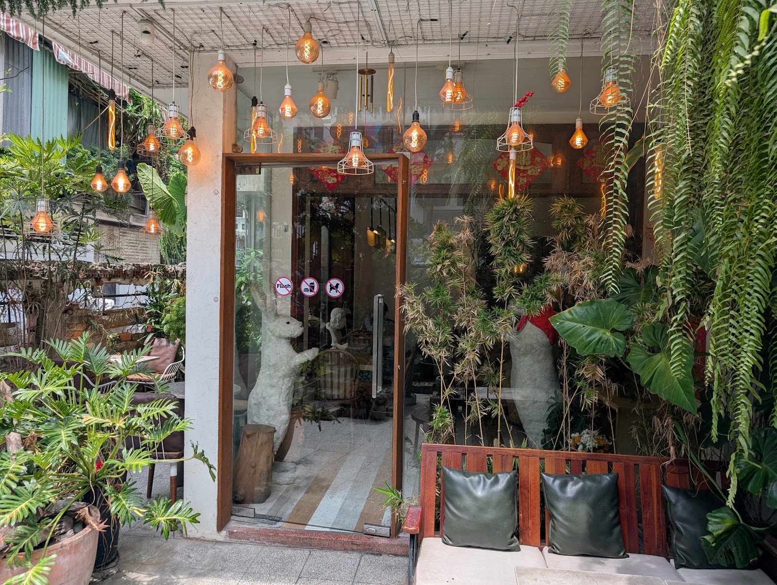 The entrance with hanging bulbs and ferns