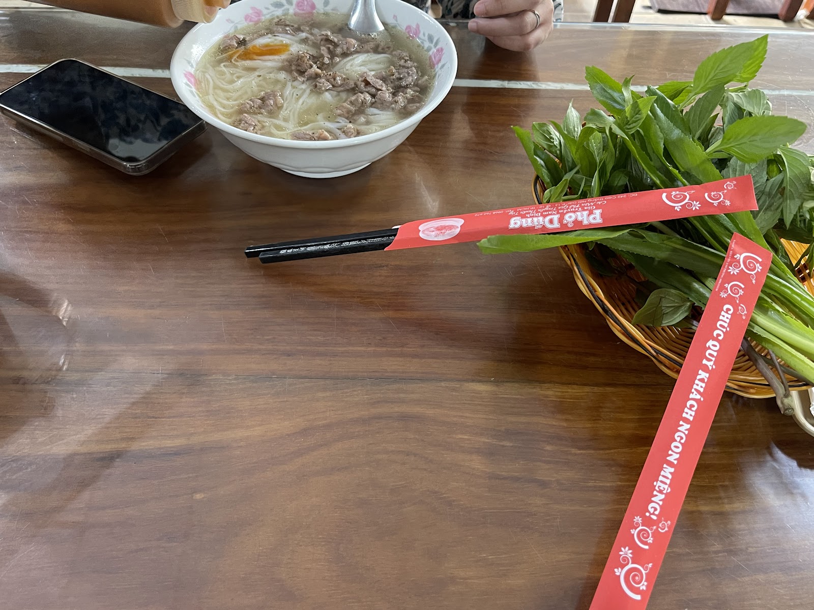 Pho bowl on wooden table — photo from Google Maps