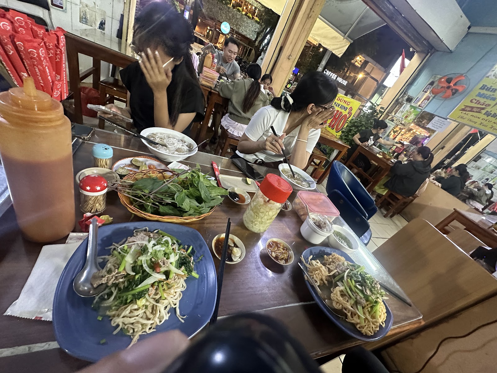 Table with pho and stir-fried glass noodles — photo from Google Maps