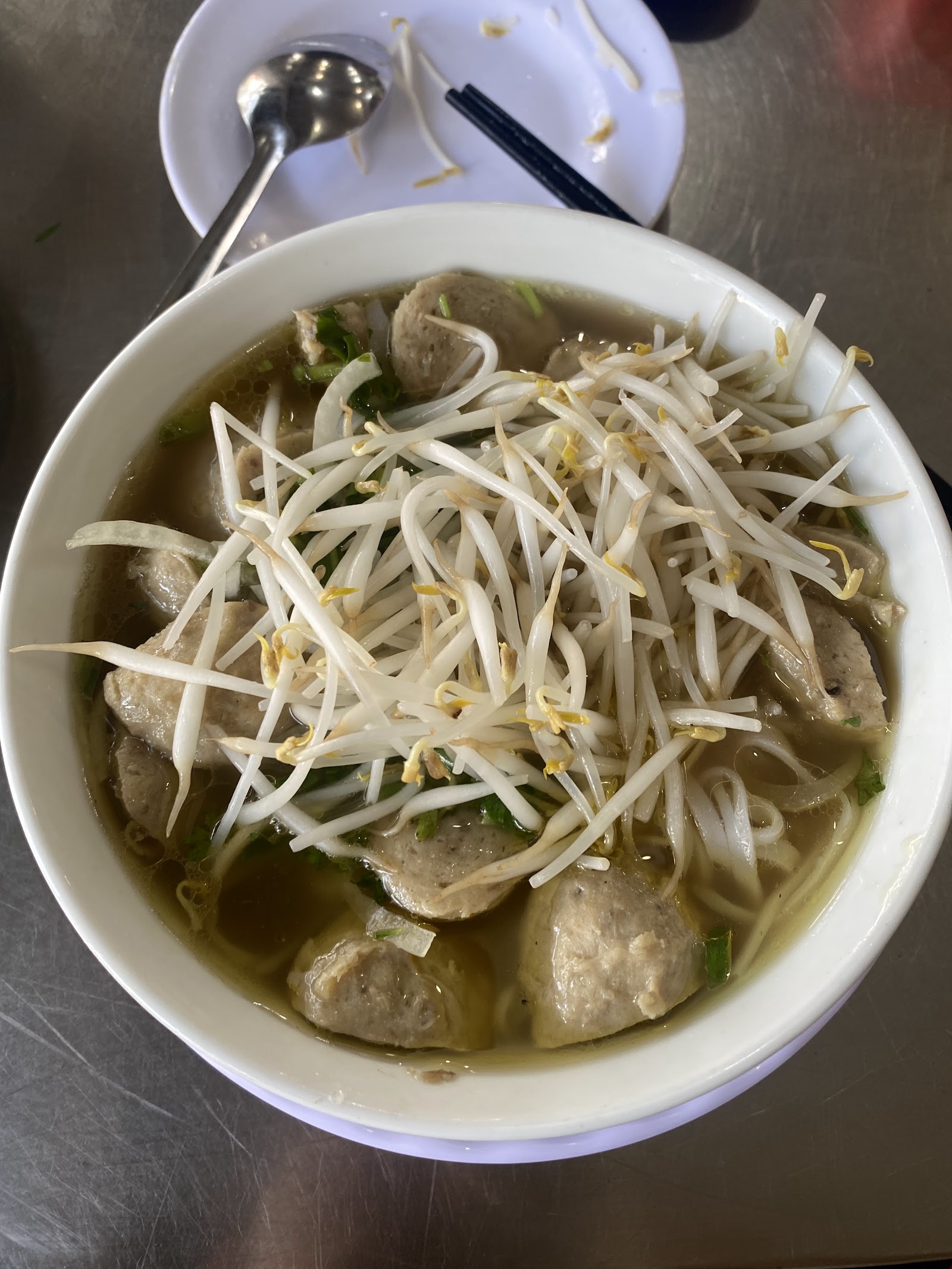 Brisket beef-pho bowl full of scallions with a dipping bowl