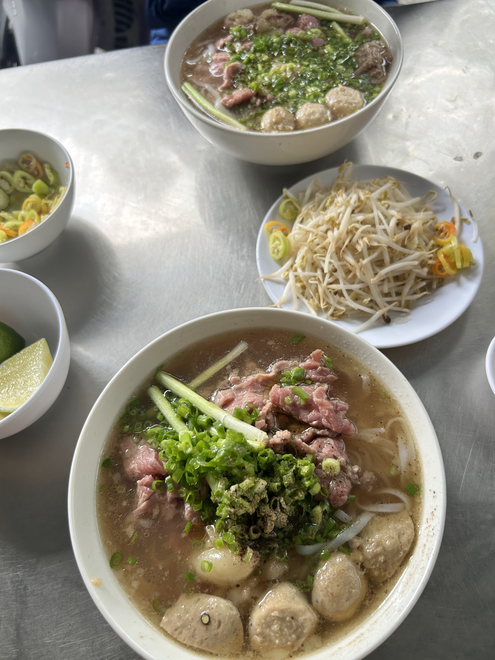Two pho bowls on steel table — photo from Google Maps
