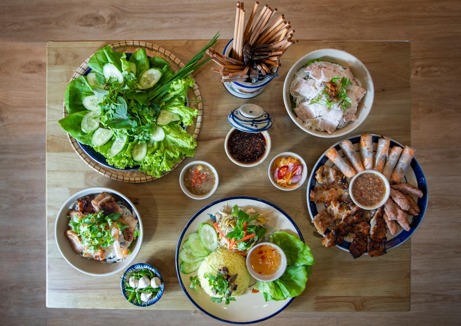 The first-floor dining space of Quán Xóm Chợ Cũ, teal shutters and all (pending the venue photo pass)