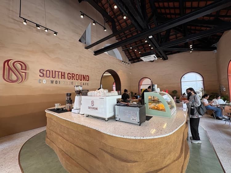 The ground-floor café counter with curved clay bar and pastry case