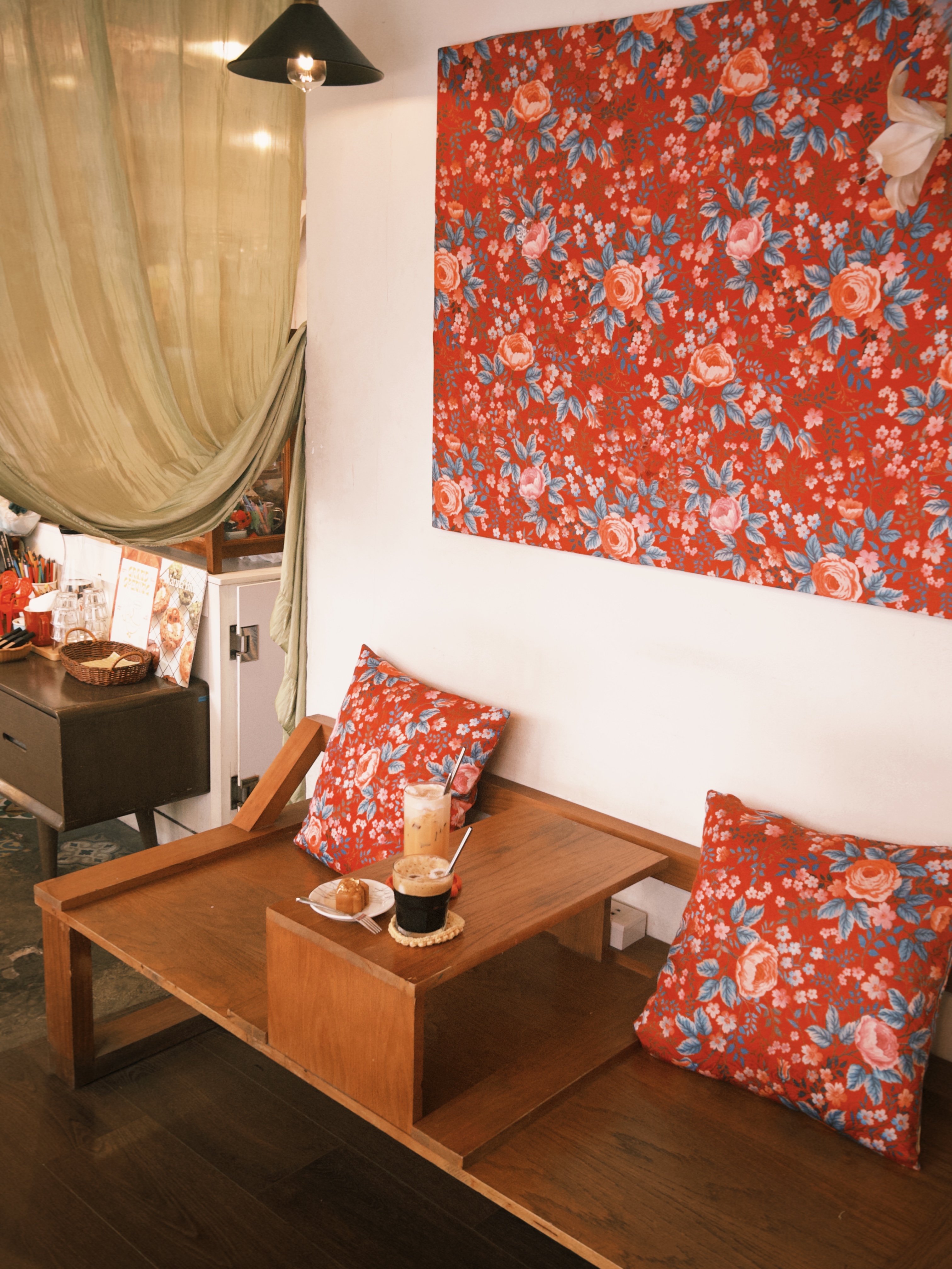 Wooden daybed with floral cushions