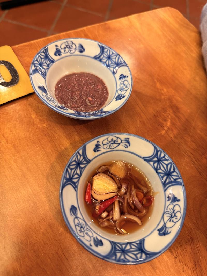 Bowls of mam tom and pickled shallots with chili