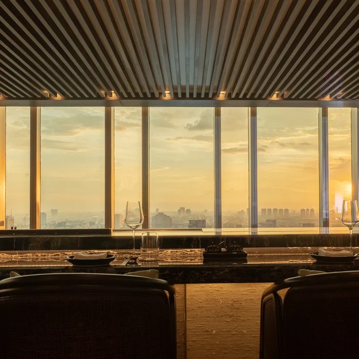 Place settings at Towa's counter as the sun hangs low over the skyline