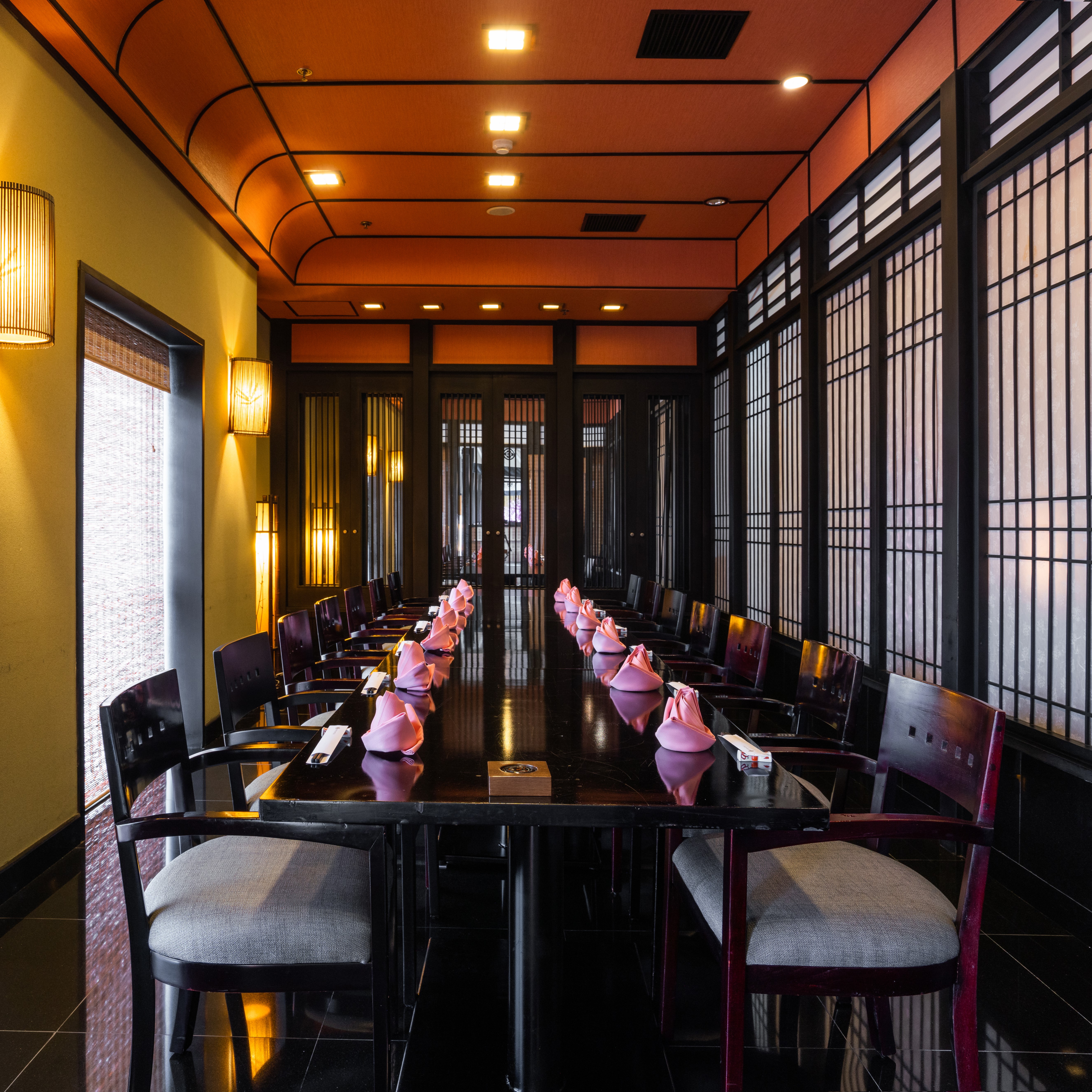 The Yoshino arrival — the lantern-lit corridor from the Lotte lobby, framed kimono art on the wall