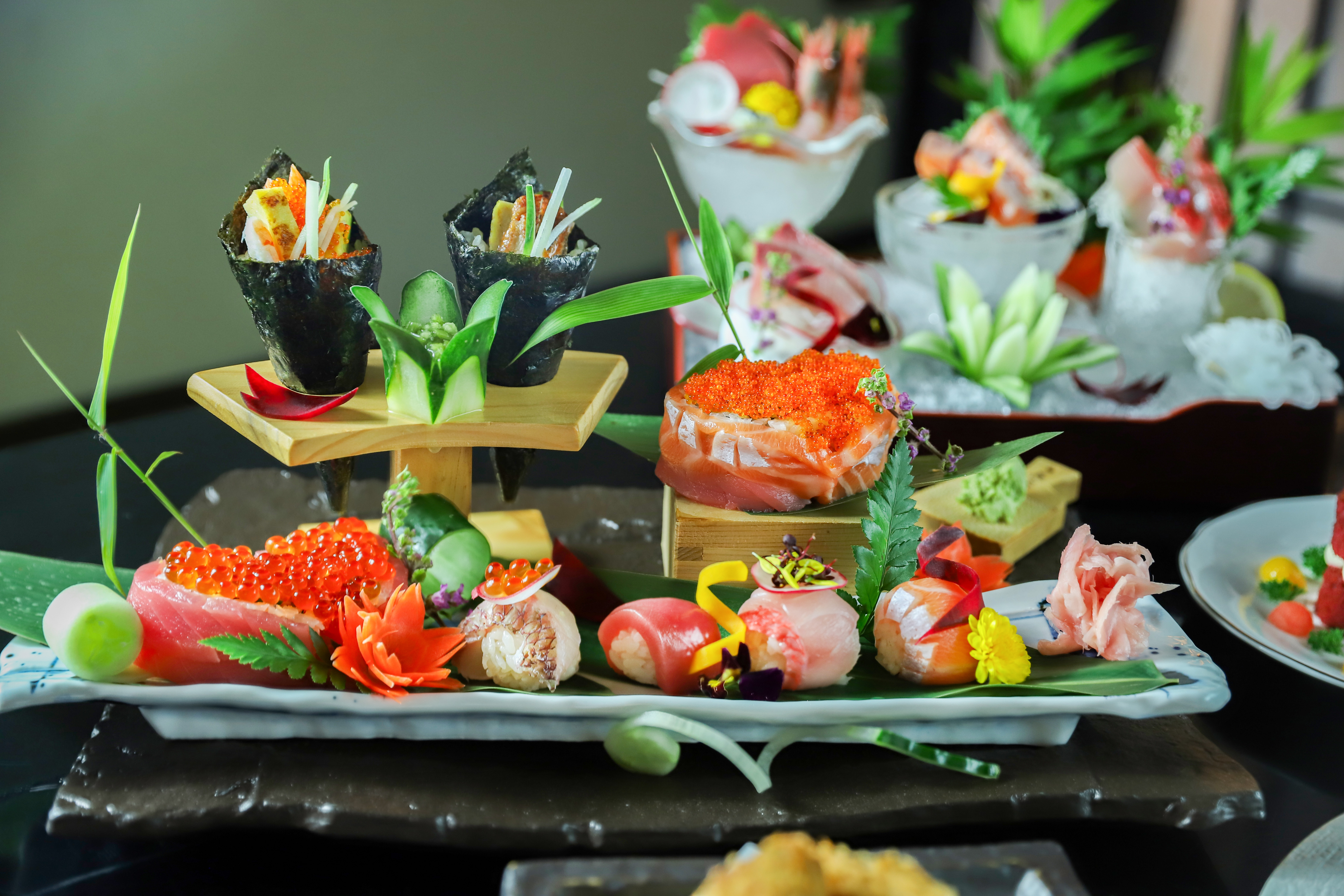 Yoshino's grand sushi spread — temaki cones, ikura-topped salmon, sashimi moriawase